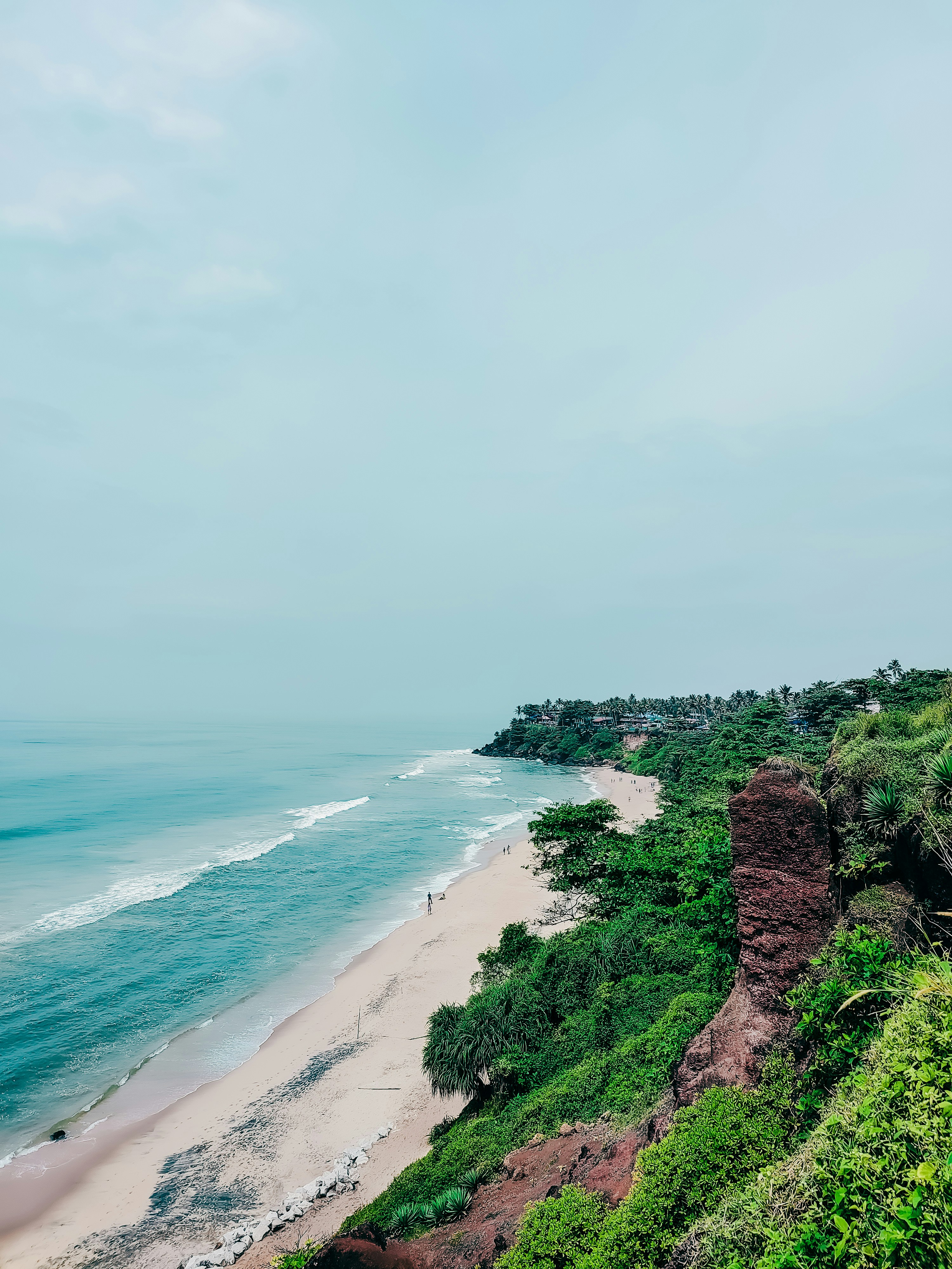Pristine Malvan Konkan coastline with turquoise Arabian Sea waters and lush green coastal cliffs